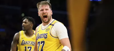 Los Angeles Lakers guard Luka Doncic (77) reacts after making a shot during the second half of an NBA basketball game against the Charlotte Hornets, Wednesday, Feb. 19, 2025, in Los Angeles. (AP Photo/William Liang)