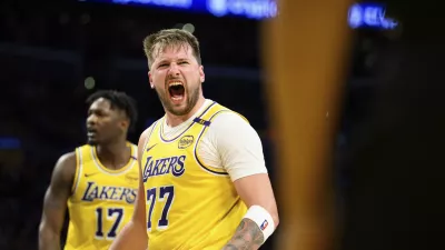 Los Angeles Lakers guard Luka Doncic (77) reacts after making a shot during the second half of an NBA basketball game against the Charlotte Hornets, Wednesday, Feb. 19, 2025, in Los Angeles. (AP Photo/William Liang)