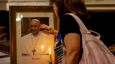 19 February 2025, Argentina, Buenos Aires: A woman stands in front of Pope Francis' picture during a mass held for his health in the Basilica of San Jose de Flores. Photo: Cristina Sille/dpa