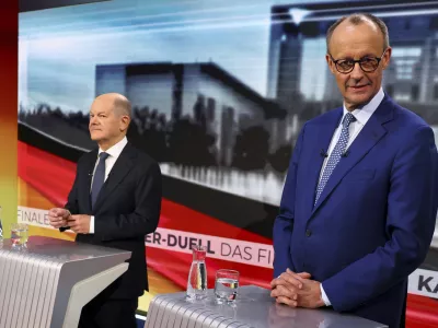 Olaf Scholz, German Chancellor of the Social Democratic Party (SPD), left, and Friedrich Merz, right, leader of the Christian Democratic Union (CDU), are pictured in tv studio ahead of a debate in Berlin, Germany, Wednesday, Feb. 19, 2025. (Fabrizio Bensch/Pool Photo via AP)