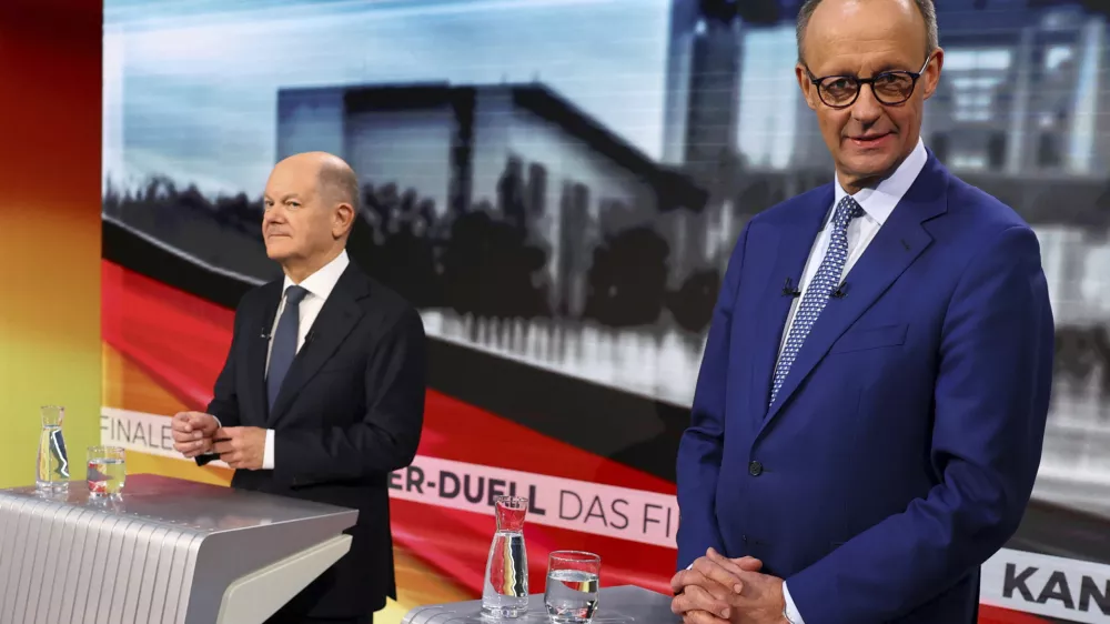 Olaf Scholz, German Chancellor of the Social Democratic Party (SPD), left, and Friedrich Merz, right, leader of the Christian Democratic Union (CDU), are pictured in tv studio ahead of a debate in Berlin, Germany, Wednesday, Feb. 19, 2025. (Fabrizio Bensch/Pool Photo via AP)