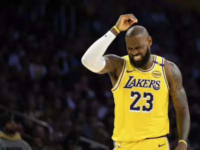 Los Angeles Lakers forward LeBron James (23) reacts after getting hit in the head during the second half of an NBA basketball game against the Charlotte Hornets, Wednesday, Feb. 19, 2025, in Los Angeles. (AP Photo/William Liang)