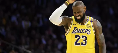 Los Angeles Lakers forward LeBron James (23) reacts after getting hit in the head during the second half of an NBA basketball game against the Charlotte Hornets, Wednesday, Feb. 19, 2025, in Los Angeles. (AP Photo/William Liang)