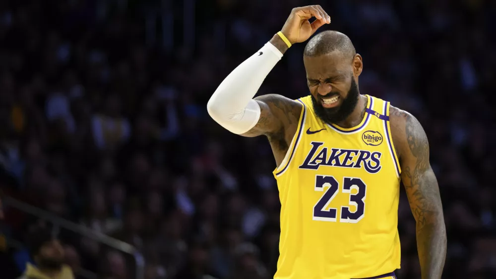 Los Angeles Lakers forward LeBron James (23) reacts after getting hit in the head during the second half of an NBA basketball game against the Charlotte Hornets, Wednesday, Feb. 19, 2025, in Los Angeles. (AP Photo/William Liang)