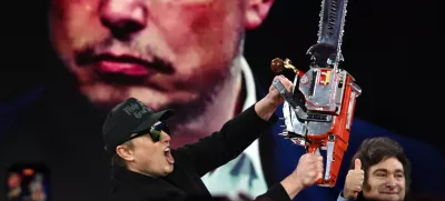 21 February 2025, US, Oxen Hill: Elon Musk is given a chainsaw as a gift by Argentine President Javier Millei during his appearance at CPAC, the annual Conservative Political Action Conference at the Gaylord Convention Center in Oxen Hill MD. Photo: Carol Guzy/ZUMA Press Wire/dpa