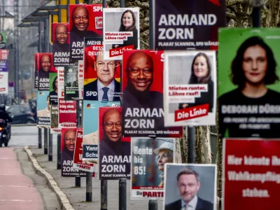 Election posters of various parties are fixed at lamp poles in central Frankfurt, Germany, Thursday, Feb. 20, 2025. (AP Photo/Michael Probst)