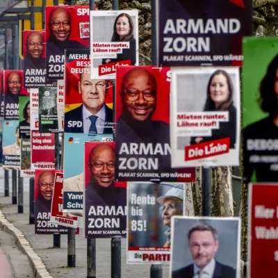 Election posters of various parties are fixed at lamp poles in central Frankfurt, Germany, Thursday, Feb. 20, 2025. (AP Photo/Michael Probst)