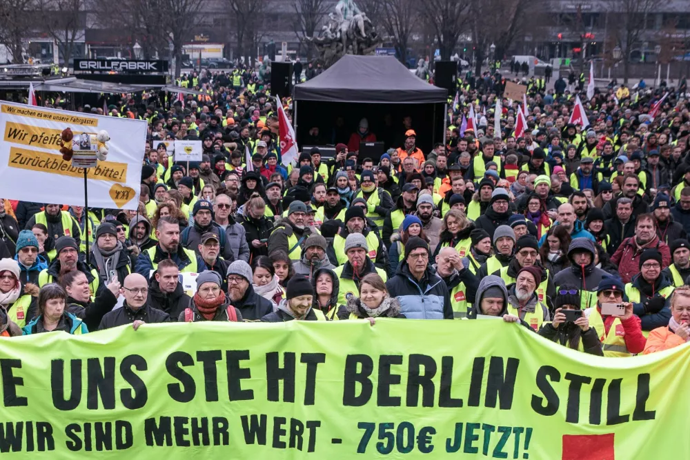 21 February 2025, Berlin: Members of various professions demonstrate with Verdi flags at a rally in front of the Rotes Rathaus. Verdi calls for a warning strike at Stromnetz Berlin, BEW Berliner Energie und Wärme, Berliner Stadtreinigung and Berliner Wasserbetriebe on the occasion of collective bargaining for more than 2.5 million public sector employees at federal and municipal level. Photo: Carsten Koall/dpa