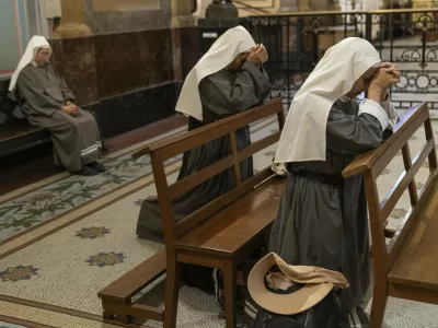 Missionary nuns pray for the health of Pope Francis at the Metropolitan Cathedral in Buenos Aires, Argentina, Friday, Feb. 21, 2025. (AP Photo/Rodrigo Abd)