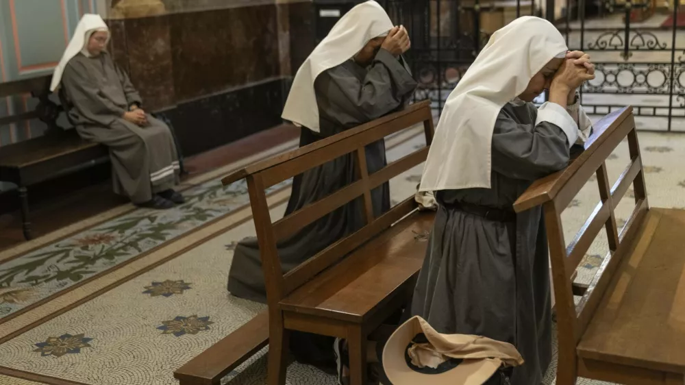 Missionary nuns pray for the health of Pope Francis at the Metropolitan Cathedral in Buenos Aires, Argentina, Friday, Feb. 21, 2025. (AP Photo/Rodrigo Abd)