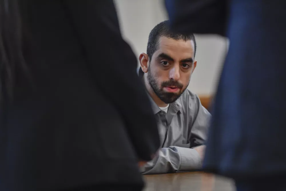 Hadi Matar, charged with severely injuring author Salman Rushdie in a 2022 knife attack, sits in Chautauqua County court after being found guilty on all counts in Mayville, N.Y., Friday, Feb. 21, 2025. (AP Photo/Adrian Kraus)