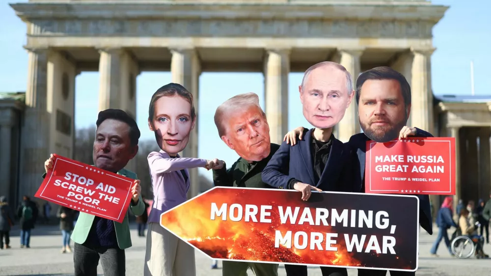 People wearing head cut-outs depicting U.S. President Donald Trump, U.S. Vice President JD Vance, Elon Musk, Russian President Vladimir Putin and Alternative for Germany (AfD) party co-leader Alice Weidel hold placards during a protest at the Brandenburg Gate in Berlin, Germany, February 20, 2025. REUTERS/Lisi Niesner