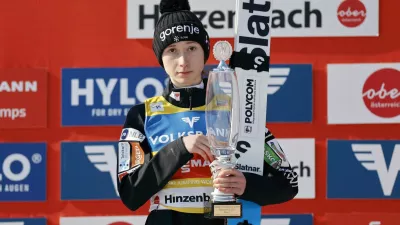 Ski Jumping - FIS Ski Jumping World Cup - Hinzenbach, Austria - February 22, 2025 Slovenia's Nika Prevc celebrates on the podium with a trophy after winning in the Women's Normal Hill Individual REUTERS/Lisa Leutner