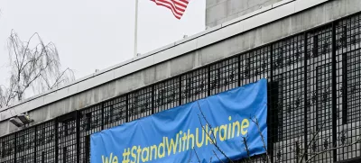 U.S. flag flutters next to a banner that reads "We #StandWithUkraine" at the U.S. embassy in Stockholm, Sweden February 22, 2025. TT News Agency/Jonas Ekstromer/via REUTERS   ATTENTION EDITORS - THIS IMAGE WAS PROVIDED BY A THIRD PARTY. SWEDEN OUT. NO COMMERCIAL OR EDITORIAL SALES IN SWEDEN.