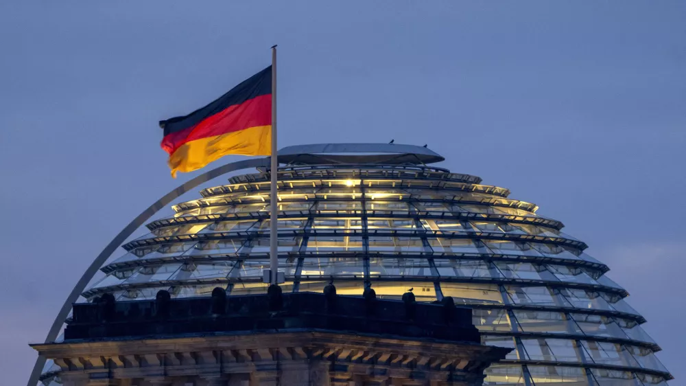 A German national flag waves on top of the Reichstag building in Berlin, Germany, Sunday, Feb. 23, 2025. (AP Photo/Michael Probst)