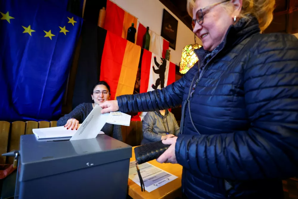 A woman votes at a polling station in a pub during the 2025 general election, in Berlin, Germany, February 23, 2025. REUTERS/Fabrizio Bensch