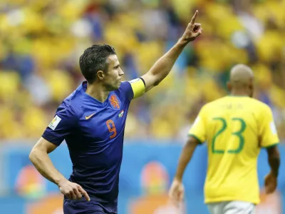 ﻿Robin van Persie of the Netherlands celebrates after scoring a goal from a penalty kick during their 2014 World Cup third-place playoff against Brazil at the Brasilia national stadium in Brasilia July 12, 2014. REUTERS/Dominic Ebenbichler (BRAZIL - Tags: SOCCER SPORT WORLD CUP)    TOPCUP