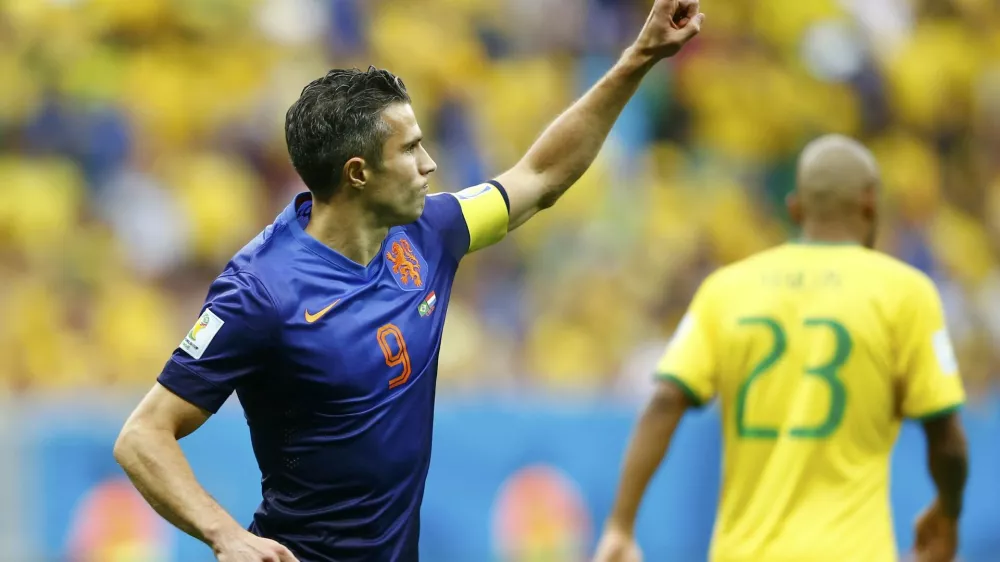 ﻿Robin van Persie of the Netherlands celebrates after scoring a goal from a penalty kick during their 2014 World Cup third-place playoff against Brazil at the Brasilia national stadium in Brasilia July 12, 2014. REUTERS/Dominic Ebenbichler (BRAZIL - Tags: SOCCER SPORT WORLD CUP)    TOPCUP