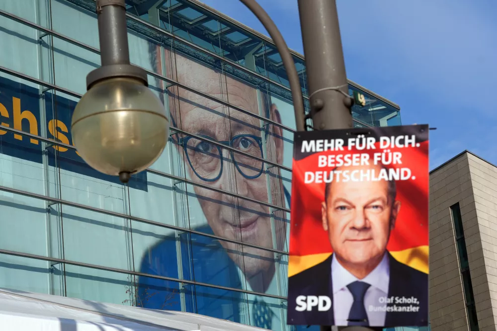 24 February 2025, Berlin: An Social Democratic Party of Germany (SPD) election poster and another of Christian Democratic Union (CDU) federal chairman Merz hangs in front of the Konrad Adenauer House. The committees of the federal parties meet for consultations after the election to the 21st German Bundestag. Photo: Marcus Brandt/dpa