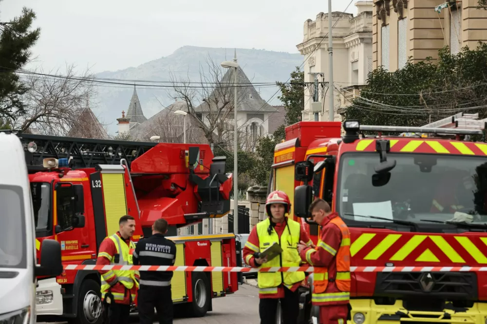 French firefighters and rescue forces stand near the entrance of the Russian consulate in Marseille after the consul general confirmed there had been an explosion, in Marseille, France, February 25, 2025. REUTERS/Stringer