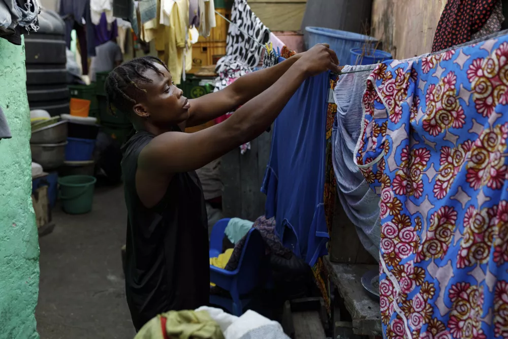 Abigail Kwartekaa Quartey hangs her training kits on the clothesline in her house in the Jamestown district in Accra, Ghana, Wednesday, Jan. 22, 2025. (AP Photo/Misper Apawu)