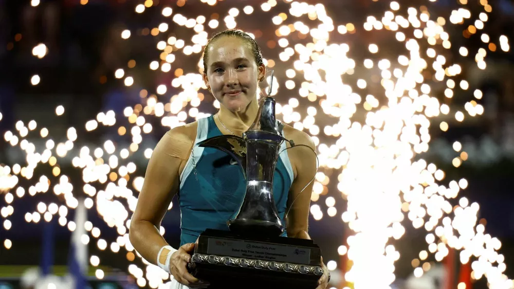 Tennis - Dubai Championships - Dubai Tennis Stadium, Dubai, United Arab Emirates - February 22, 2025 Russia's Mirra Andreeva celebrates with the trophy after winning the final against Denmark's Clara Tauson REUTERS/Rula Rouhana