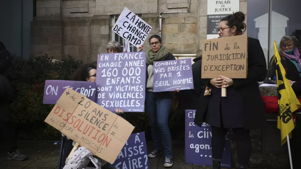 A protestor holds a banner reads: "Shame changes side", during a protest outside the Vannes courthouse, western France, on the opening day of the trial of French surgeon Joel Le Scouarnec accused of raping or abusing 299 people, mostly child patients, Monday, Feb. 24, 2025. (AP Photo/Thomas Padilla)