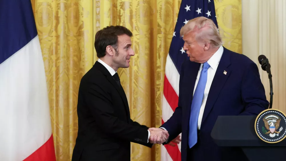 U.S. President Donald Trump and French President Emmanuel Macron shake hands during a press conference, at the White House in Washington, D.C., U.S., February 24, 2025. REUTERS/Evelyn Hockstein   TPX IMAGES OF THE DAY