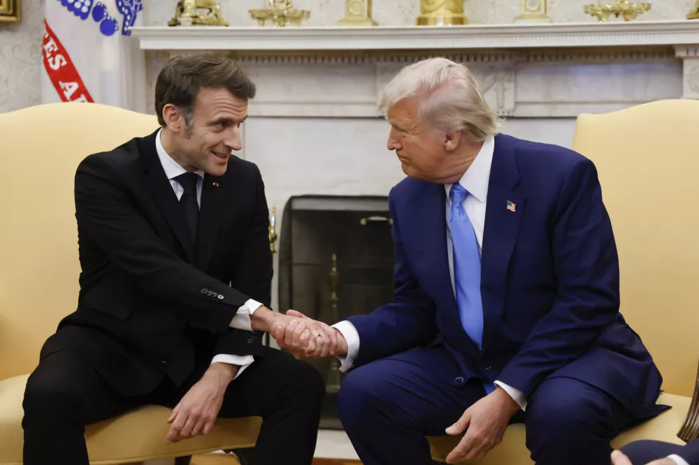 President Donald Trump, right, shakes the hand of France's President Emmanuel Macron during a meeting in the Oval Office of the White House in Washington, Monday, Feb. 24, 2025. (Ludovic Marin/Pool via AP)