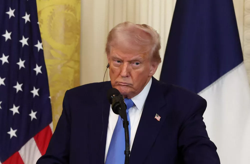 U.S. President Donald Trump looks on during a press conference held along with French President Emmanuel Macron (not pictured), at the White House in Washington, D.C., U.S., February 24, 2025. REUTERS/Evelyn Hockstein