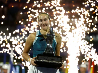 Tennis - Dubai Championships - Dubai Tennis Stadium, Dubai, United Arab Emirates - February 22, 2025 Russia's Mirra Andreeva celebrates with the trophy after winning the final against Denmark's Clara Tauson REUTERS/Rula Rouhana