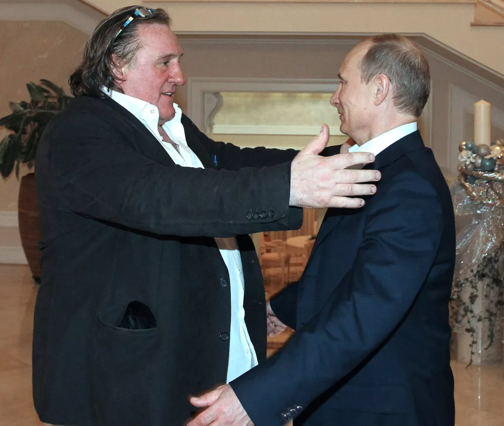 French actor Gerard Depardieu, left, greets Russian President Vladimir Putin after his arrival late Saturday, Jan. 5, 2013, at the president's residence in Sochi, the host city of the 2014 Winter Olympics. Depardieu has received a Russian passport after flying to Russia for a late night dinner with Putin. Depardieu sought Russian citizenship as part of his battle against a proposed super tax on millionaires in France, and Putin granted his request last week. (AP Photo/RIA-Novosti, Mikhail Klimentyev, Presidential Press Service)