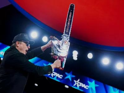 FILE PHOTO: Elon Musk holds up a chainsaw onstage during the Conservative Political Action Conference (CPAC) in National Harbor, Maryland, U.S., February 20, 2025. REUTERS/Nathan Howard    TPX IMAGES OF THE DAY/File Photo