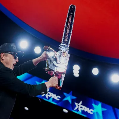 FILE PHOTO: Elon Musk holds up a chainsaw onstage during the Conservative Political Action Conference (CPAC) in National Harbor, Maryland, U.S., February 20, 2025. REUTERS/Nathan Howard    TPX IMAGES OF THE DAY/File Photo