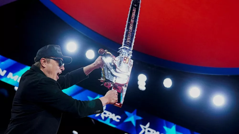 FILE PHOTO: Elon Musk holds up a chainsaw onstage during the Conservative Political Action Conference (CPAC) in National Harbor, Maryland, U.S., February 20, 2025. REUTERS/Nathan Howard    TPX IMAGES OF THE DAY/File Photo