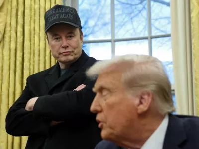 FILE PHOTO: Elon Musk listens to U.S. President Donald Trump speak in the Oval Office of the White House in Washington, D.C., U.S., February 11, 2025.  REUTERS/Kevin Lamarque/File Photo