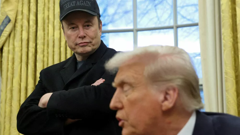 FILE PHOTO: Elon Musk listens to U.S. President Donald Trump speak in the Oval Office of the White House in Washington, D.C., U.S., February 11, 2025.  REUTERS/Kevin Lamarque/File Photo