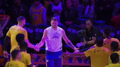 Los Angeles Lakers guard Luka Doncic, center, is introduced before an NBA basketball game against the Dallas Mavericks, Tuesday, Feb. 25, 2025, in Los Angeles. (AP Photo/Kyusung Gong)