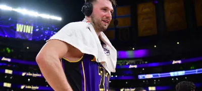 Feb 25, 2025; Los Angeles, California, USA; Los Angeles Lakers guard Luka Doncic (77) speaks to the media after the game against the Dallas Mavericks reacts at Crypto.com Arena. Mandatory Credit: Gary A. Vasquez-Imagn Images