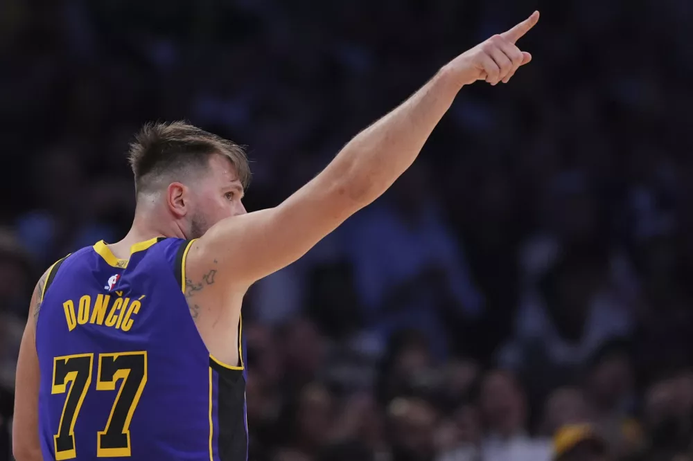 Los Angeles Lakers guard Luka Doncic reacts during the second half of an NBA basketball game against the Dallas Mavericks, Tuesday, Feb. 25, 2025, in Los Angeles. (AP Photo/Mark J. Terrill)