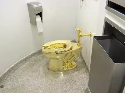 FILE - This screenshot made from a video shows the 18-karat toilet, titled "America," by Maurizio Cattelan in the restroom of the Solomon R. Guggenheim Museum in New York, Sept. 16, 2016. (AP Photo, File)