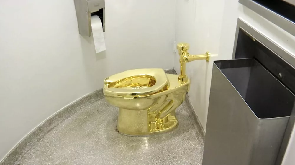 FILE - This screenshot made from a video shows the 18-karat toilet, titled "America," by Maurizio Cattelan in the restroom of the Solomon R. Guggenheim Museum in New York, Sept. 16, 2016. (AP Photo, File)