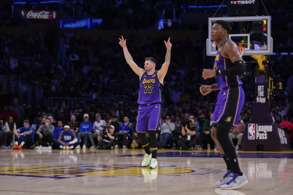 Los Angeles Lakers guard Luka Doncic (77) gestures during the first half of an NBA basketball game against the Dallas Mavericks, Tuesday, Feb. 25, 2025, in Los Angeles. (AP Photo/Mark J. Terrill)