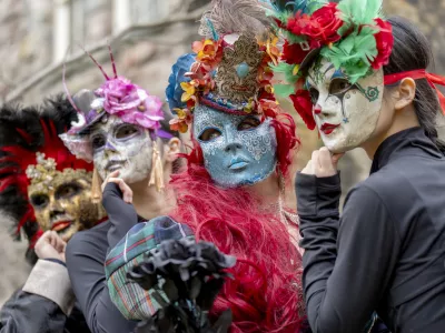 20 February 2025, United Kingdom, Edinburgh: Scottish, Polish, Chinese and Congolese dancers in colourful traditional costume masks gather at Edinburgh's Scottish Storytelling Centre to celebrate the launch of this year's programme for the Pomegranates Festival of international traditional dance. Photo: Jane Barlow/PA Wire/dpa