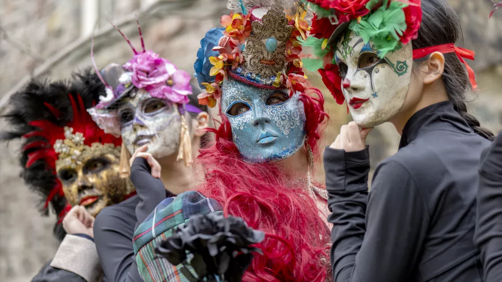 20 February 2025, United Kingdom, Edinburgh: Scottish, Polish, Chinese and Congolese dancers in colourful traditional costume masks gather at Edinburgh's Scottish Storytelling Centre to celebrate the launch of this year's programme for the Pomegranates Festival of international traditional dance. Photo: Jane Barlow/PA Wire/dpa