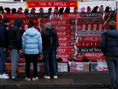 Soccer Football - Premier League - Liverpool v Newcastle United - Anfield, Liverpool, Britain - February 26, 2025 Fans look at merchandise for sale outside the stadium before the match REUTERS/Phil Noble EDITORIAL USE ONLY. NO USE WITH UNAUTHORIZED AUDIO, VIDEO, DATA, FIXTURE LISTS, CLUB/LEAGUE LOGOS OR 'LIVE' SERVICES. ONLINE IN-MATCH USE LIMITED TO 120 IMAGES, NO VIDEO EMULATION. NO USE IN BETTING, GAMES OR SINGLE CLUB/LEAGUE/PLAYER PUBLICATIONS. PLEASE CONTACT YOUR ACCOUNT REPRESENTATIVE FOR FURTHER DETAILS..