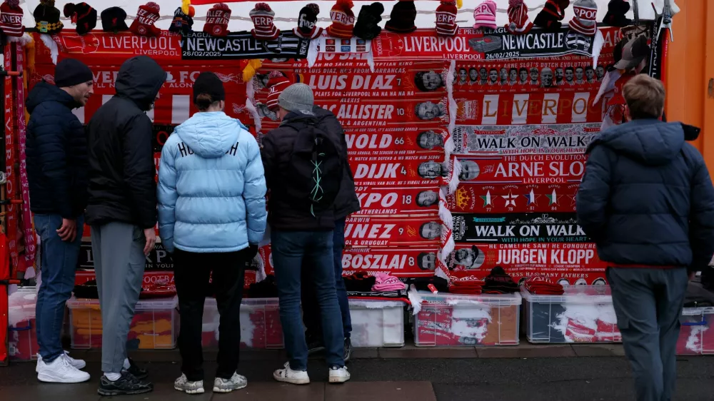 Soccer Football - Premier League - Liverpool v Newcastle United - Anfield, Liverpool, Britain - February 26, 2025 Fans look at merchandise for sale outside the stadium before the match REUTERS/Phil Noble EDITORIAL USE ONLY. NO USE WITH UNAUTHORIZED AUDIO, VIDEO, DATA, FIXTURE LISTS, CLUB/LEAGUE LOGOS OR 'LIVE' SERVICES. ONLINE IN-MATCH USE LIMITED TO 120 IMAGES, NO VIDEO EMULATION. NO USE IN BETTING, GAMES OR SINGLE CLUB/LEAGUE/PLAYER PUBLICATIONS. PLEASE CONTACT YOUR ACCOUNT REPRESENTATIVE FOR FURTHER DETAILS..