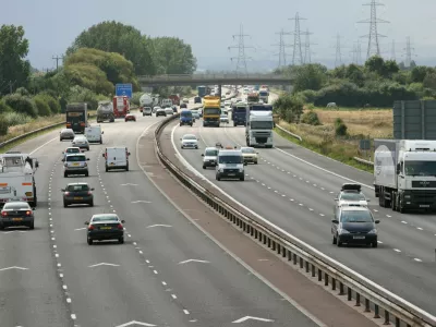 B3J880 Keep apart 2 chevrons motorway road markings and traffic on M56, Cheshire,UK. Image shot 2008. Exact date unknown.