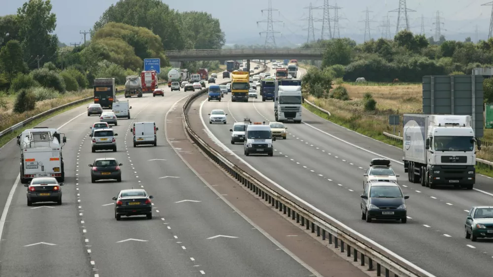 B3J880 Keep apart 2 chevrons motorway road markings and traffic on M56, Cheshire,UK. Image shot 2008. Exact date unknown.