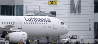 A Lufthansa aircraft stands at a gate at the Munich Airport in Munich, Germany, Thursday, Feb 27, 2025. (Sven Hoppe/dpa via AP)